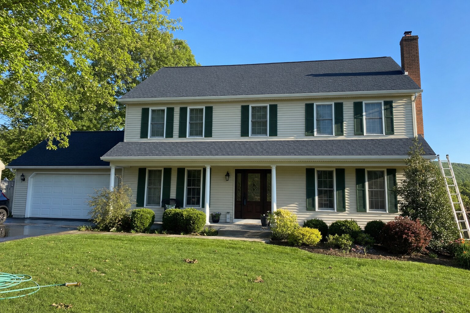 Two-story Colonial home in Hazleton with asphalt shingle roof freshly soft-washed of black algae streaks