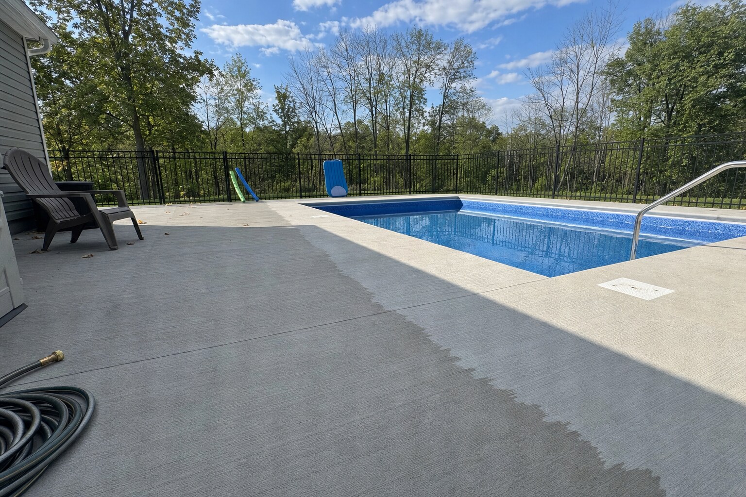 Backyard broom-finish concrete pool deck, freshly pressure-washed