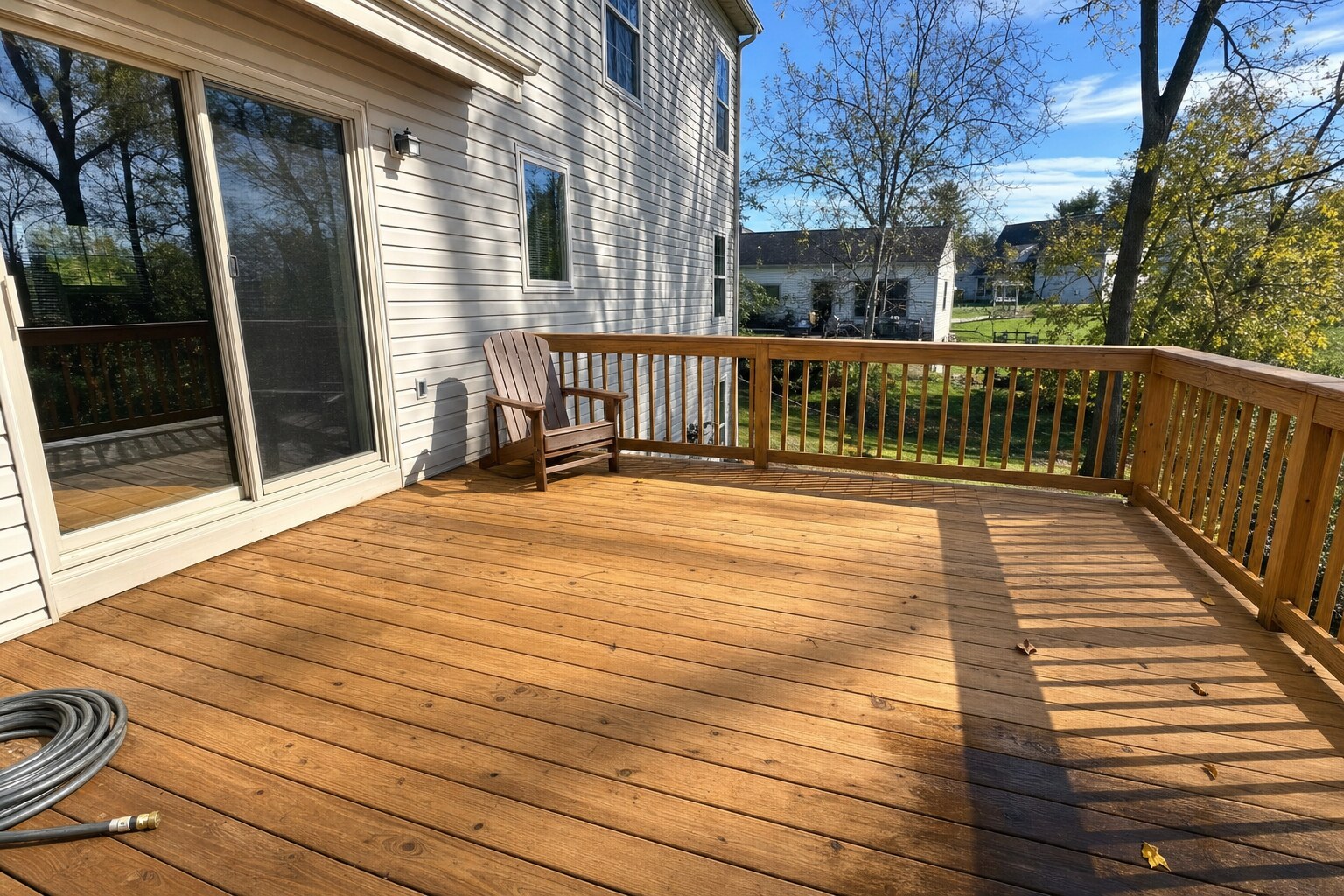 Same deck restored to warm honey-tan wood color after soft-washing